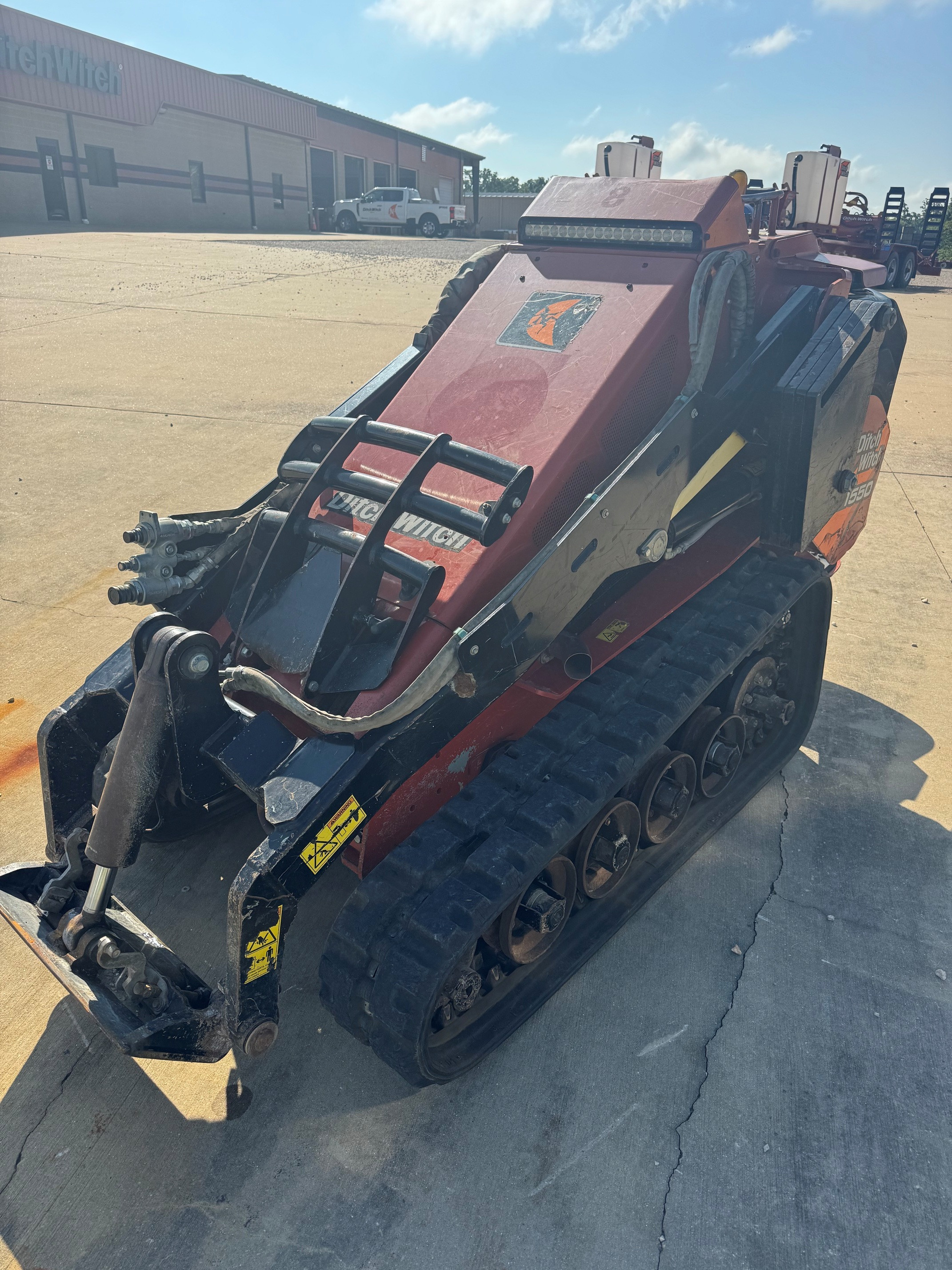2018 Ditch Witch SK1550 with weight kit and brush guard.