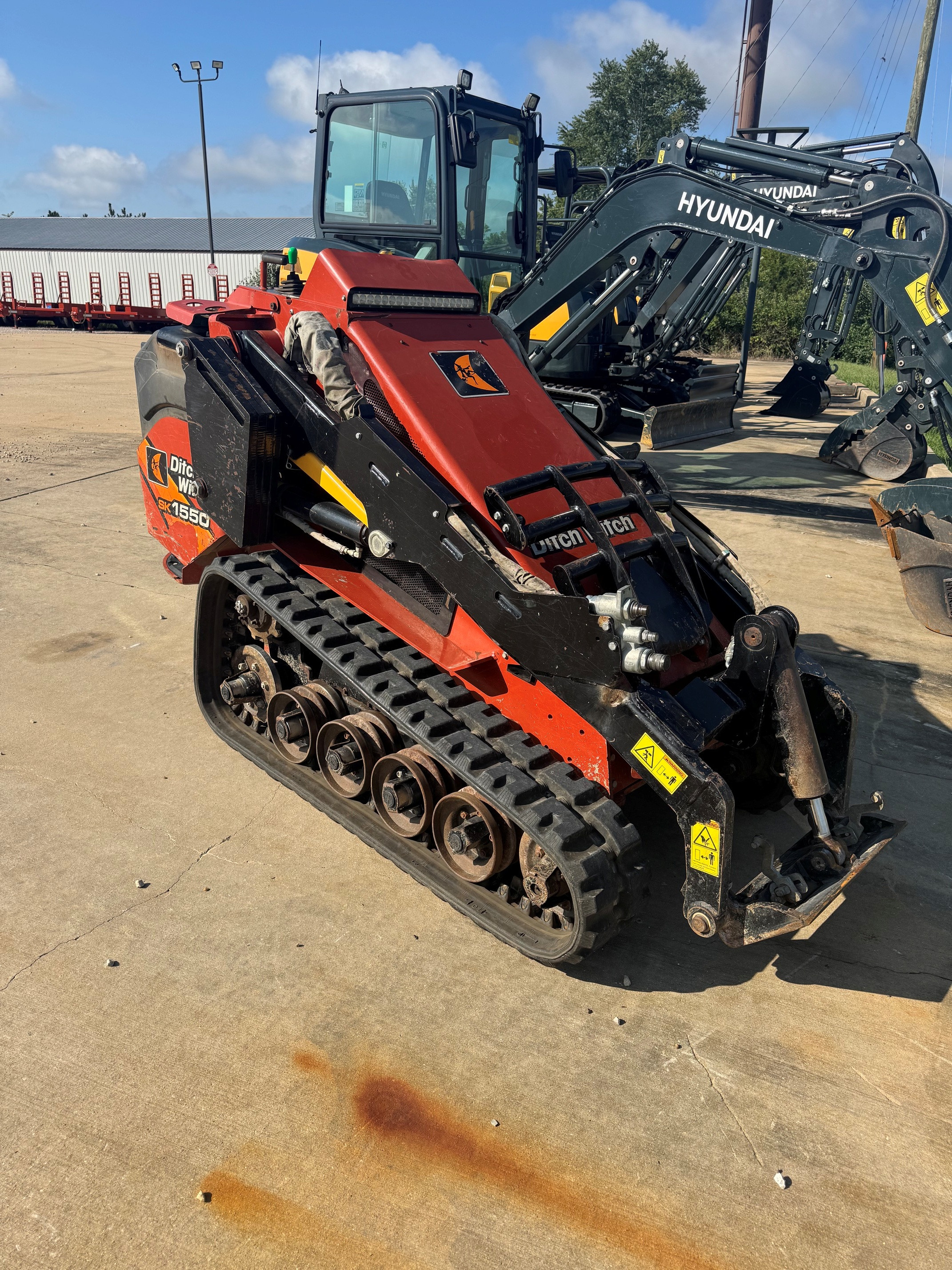 Photo of a 2018 Ditch Witch SK1550 with weight kit and brush guard.